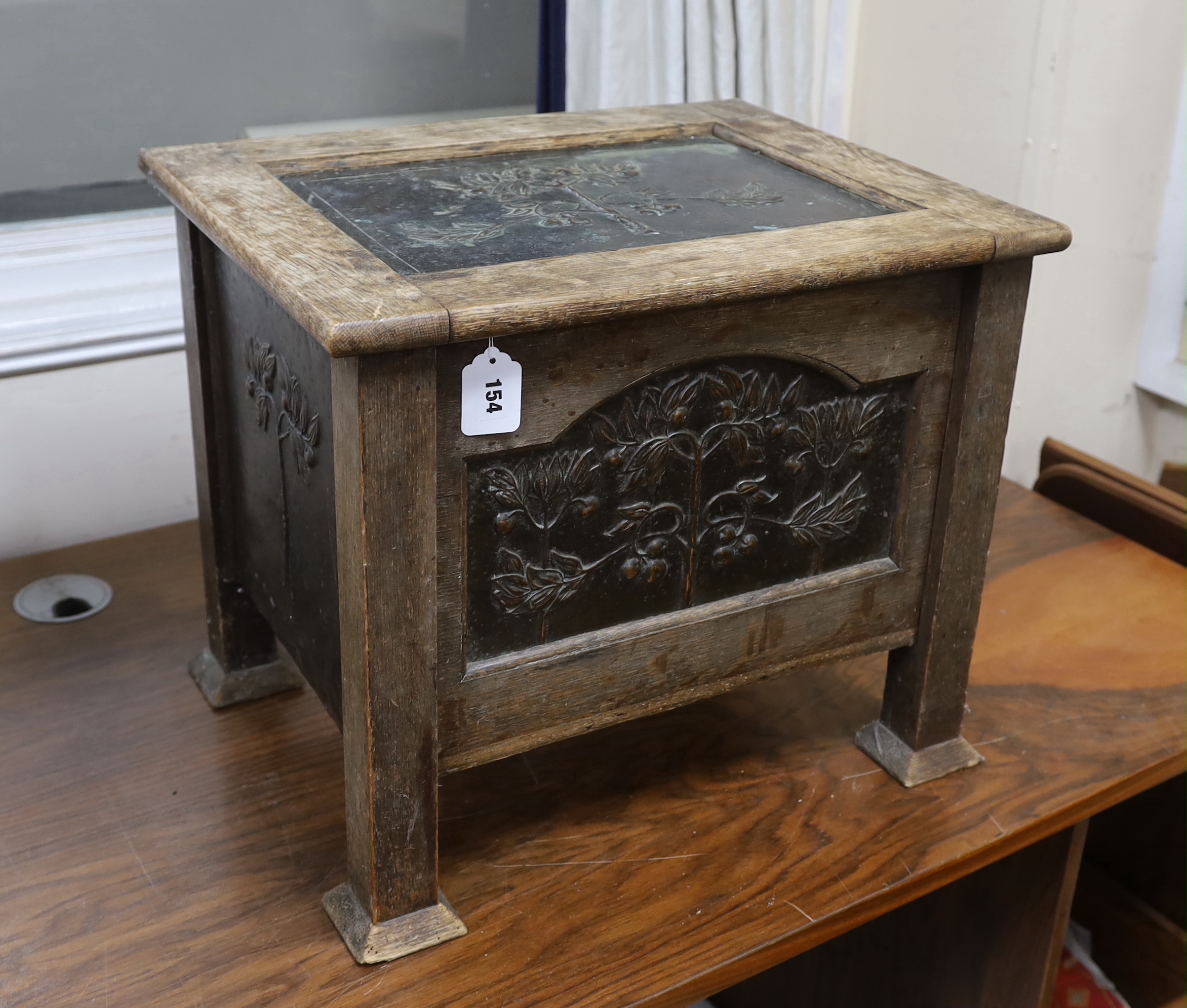 An Arts and Crafts oak and embossed copper coal box, width 54cm, depth 43cm, height 46cm
